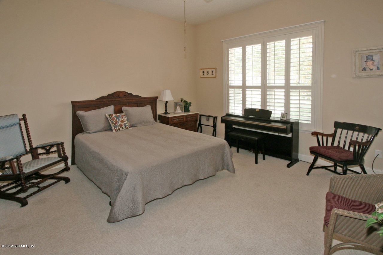 349 Fiddlers Point Drive St. Augustine, FL 32080 - Photo 20 of 27 a bedroom with a bed and a desk