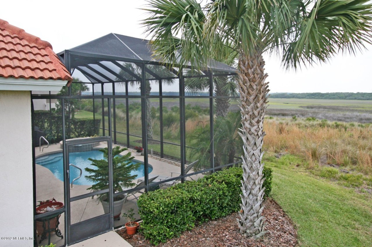 349 Fiddlers Point Drive St. Augustine, FL 32080 - Photo 6 of 27 a backyard of a house with lots of green space and fountain