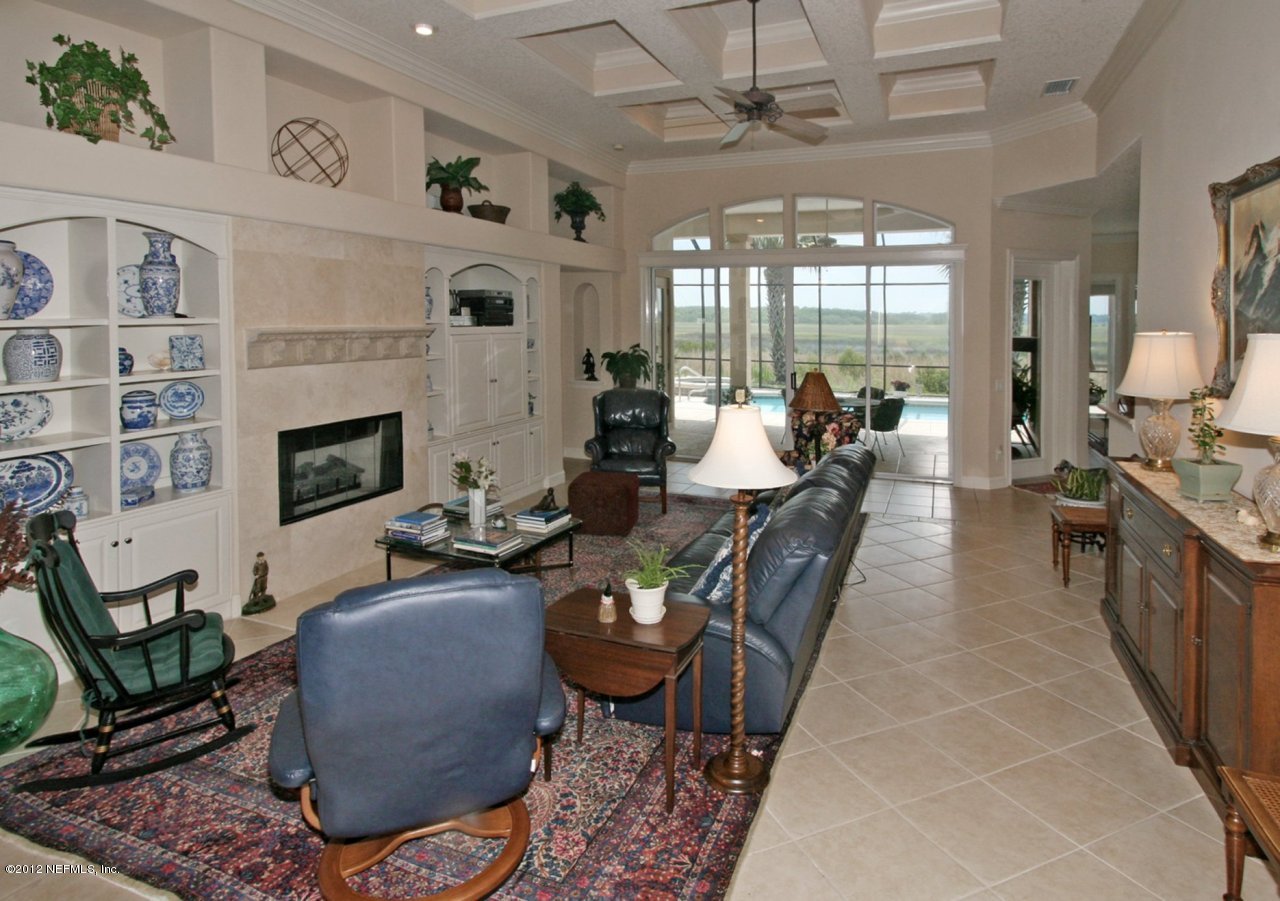 349 Fiddlers Point Drive St. Augustine, FL 32080 - Photo 9 of 27 a living room with furniture a fireplace and a chandelier