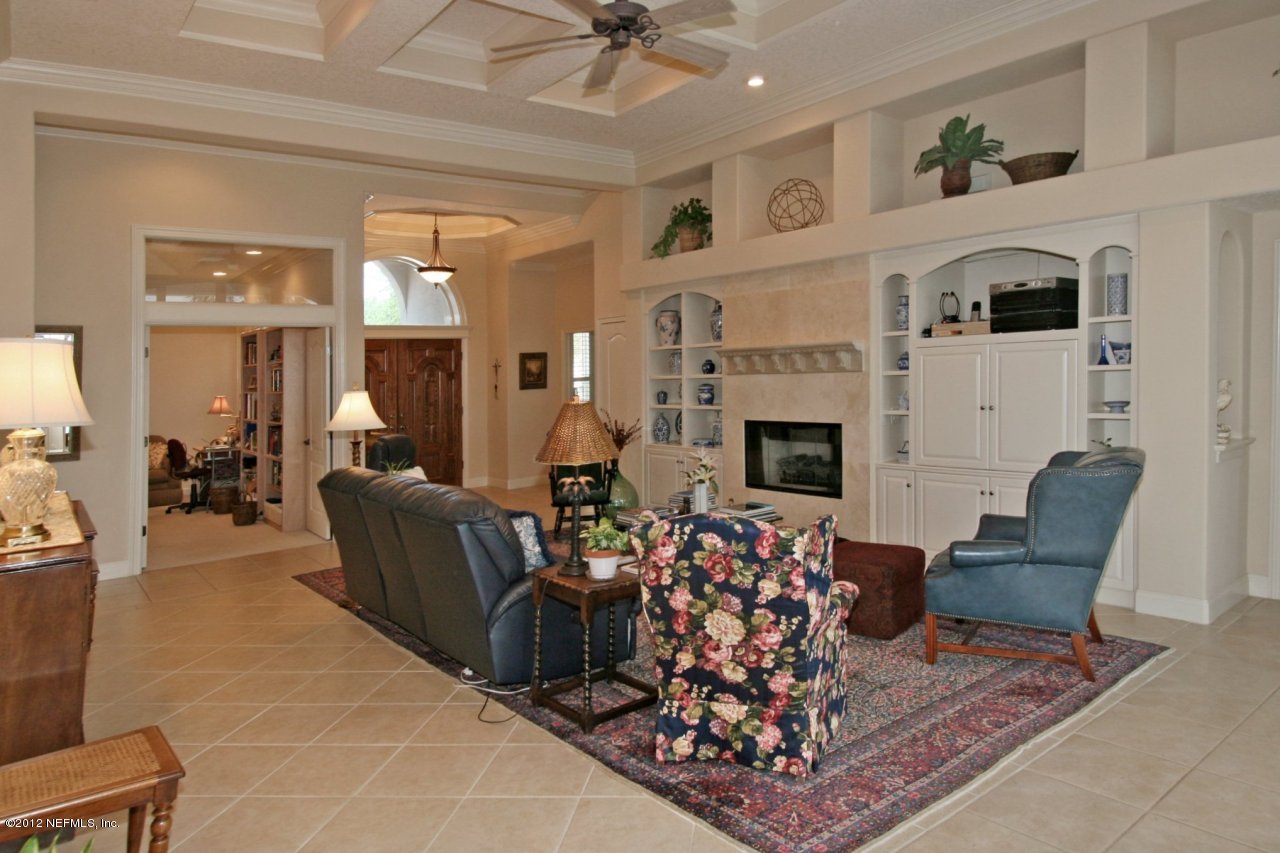 349 Fiddlers Point Drive St. Augustine, FL 32080 - Photo 10 of 27 a living room with furniture a fireplace and a chandelier