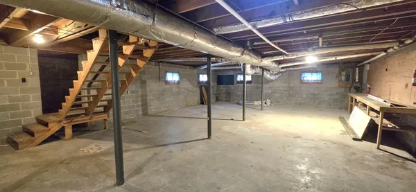 a view of empty room with wooden walls