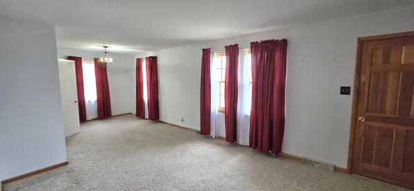 a view of a room with lots of windows and furniture