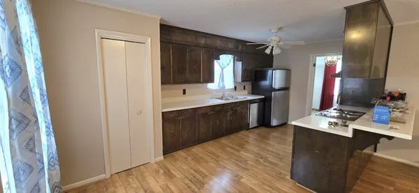 a kitchen with a sink stove and refrigerator
