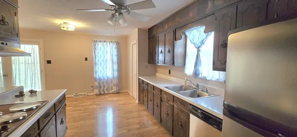 a spacious bathroom with a double vanity sink a large mirror and a shower