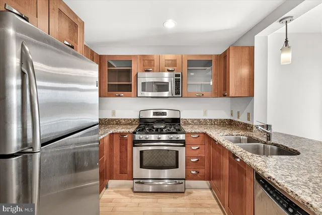 a kitchen with a stove a sink and a refrigerator