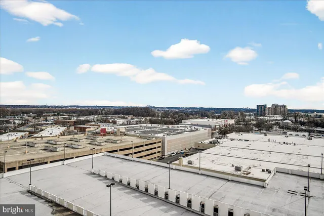 a living room with furniture and large windows