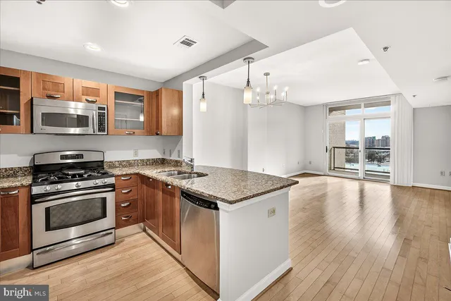 a kitchen with stainless steel appliances granite countertop a stove and a sink