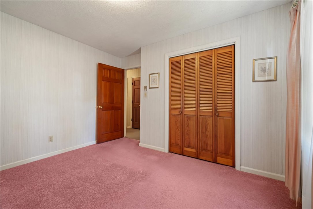 304 Shaw Road Honea Path, SC 29654 - Photo 22 of 39 This spacious room features cozy carpeting and convenient closet access, perfect for comfortable living.
