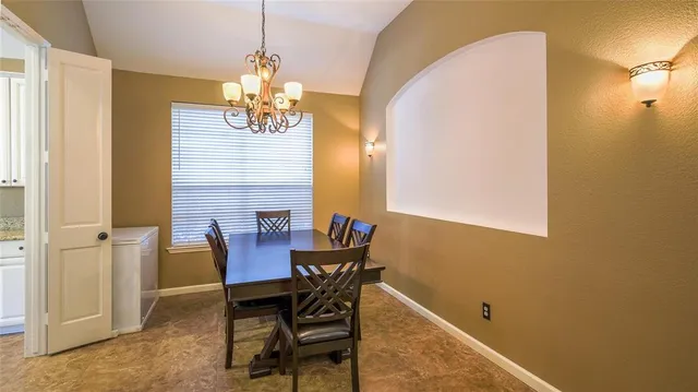 a view of a dining room with furniture and a chandelier
