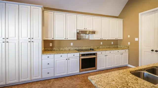 a kitchen with granite countertop cabinets and sink