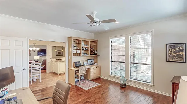 a living room with furniture cabinets and a window