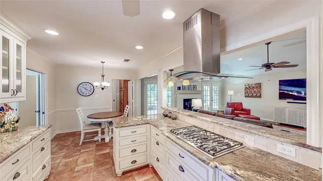 a large kitchen with stainless steel appliances granite countertop a stove and a sink
