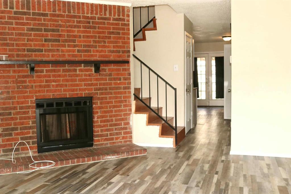 10500 Lake June Road, Unit M07 Dallas, TX 75217 - Photo 1 of 14 a view of a brick house with wooden floor and fence