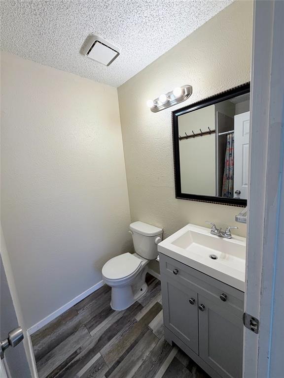 10500 Lake June Road, Unit M07 Dallas, TX 75217 - Photo 12 of 14 a bathroom with a toilet sink vanity and mirror