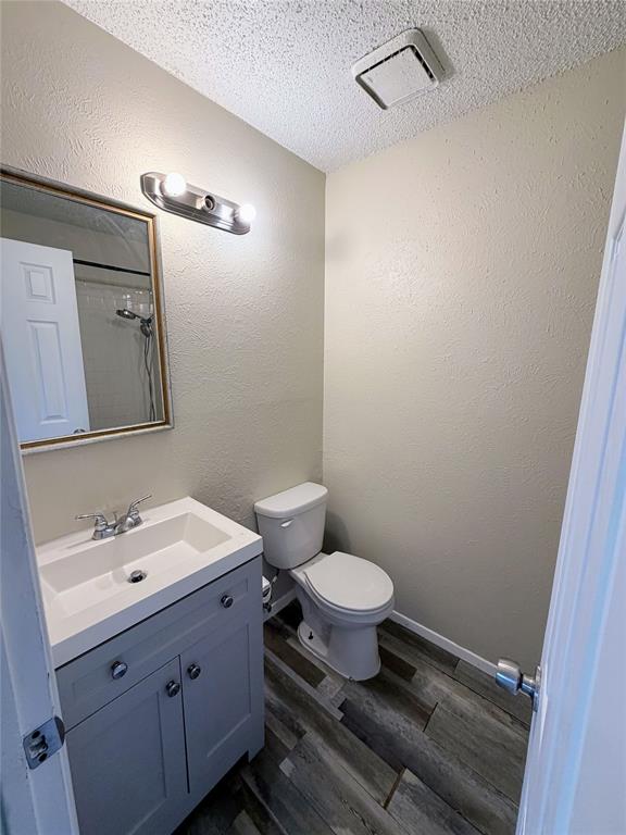 10500 Lake June Road, Unit M07 Dallas, TX 75217 - Photo 13 of 14 a bathroom with a sink toilet a mirror and vanity