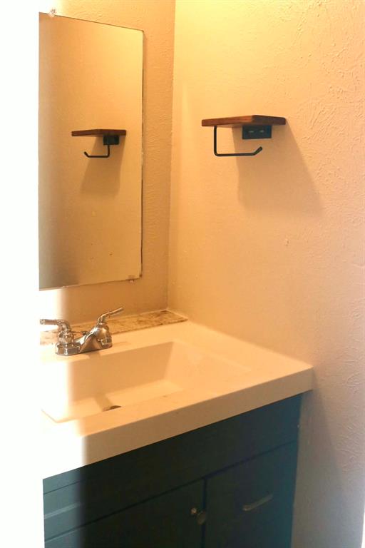 10500 Lake June Road, Unit M07 Dallas, TX 75217 - Photo 3 of 14 a bathroom with a sink and a mirror