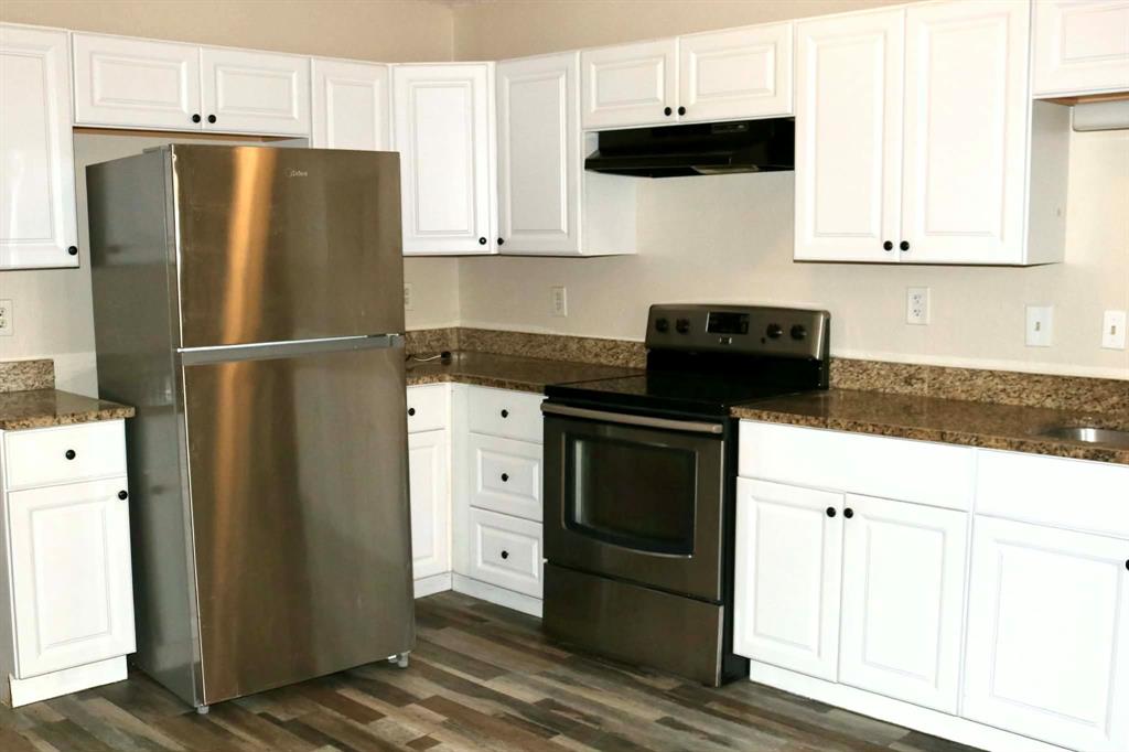 10500 Lake June Road, Unit M07 Dallas, TX 75217 - Photo 4 of 14 a white refrigerator freezer sitting in a kitchen
