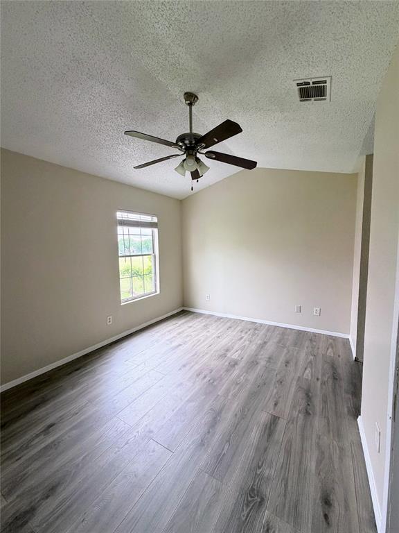 10500 Lake June Road, Unit M07 Dallas, TX 75217 - Photo 10 of 14 wooden floor in an empty room with a window