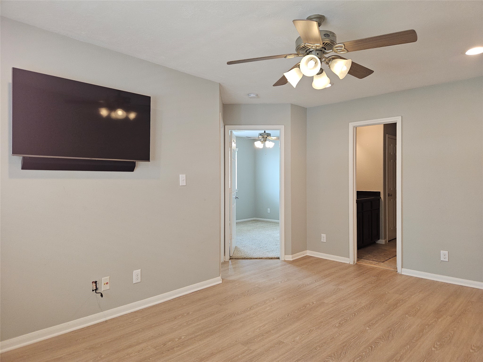 8517 Sunset Loch Drive Spring, TX 77379 - Photo 21 of 22 an empty room with wooden floor and chandelier