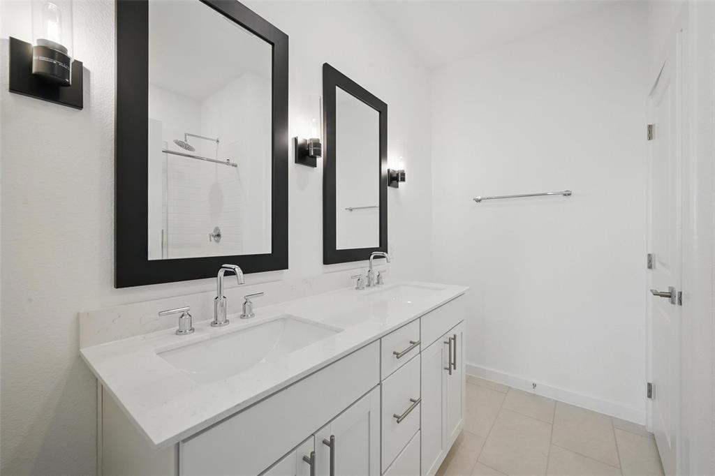 1413 Richardson Street Howe, TX 75459 - Photo 21 of 30 Dual vanity with undermount sinks, white cabinetry, and a light-toned countertop