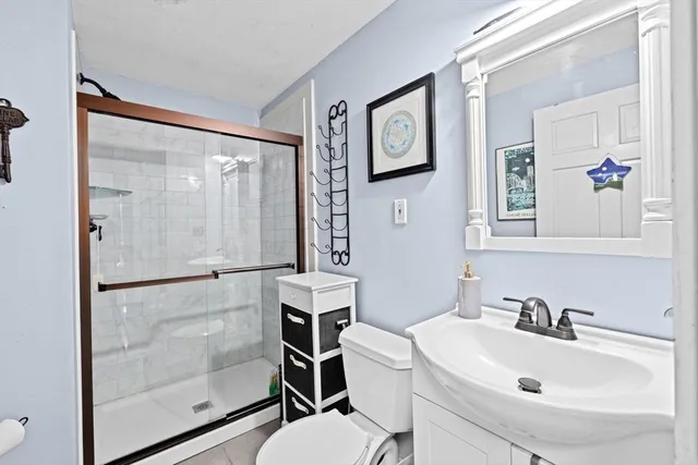 a bathroom with a sink toilet and shower