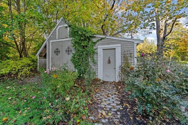 a porch with a bench next to a yard