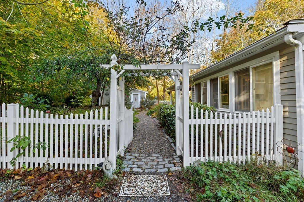 17 Old Oaken Bucket Road Scituate, MA 02066 - Photo 33 of 41 a porch with a bench next to a yard