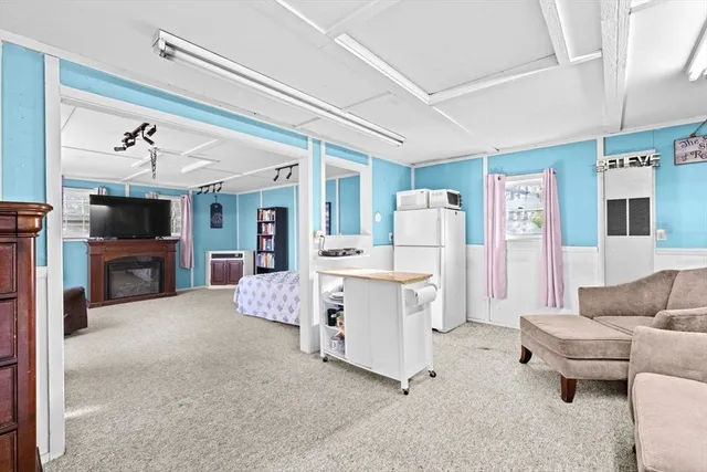 a bedroom with furniture and a flat screen tv