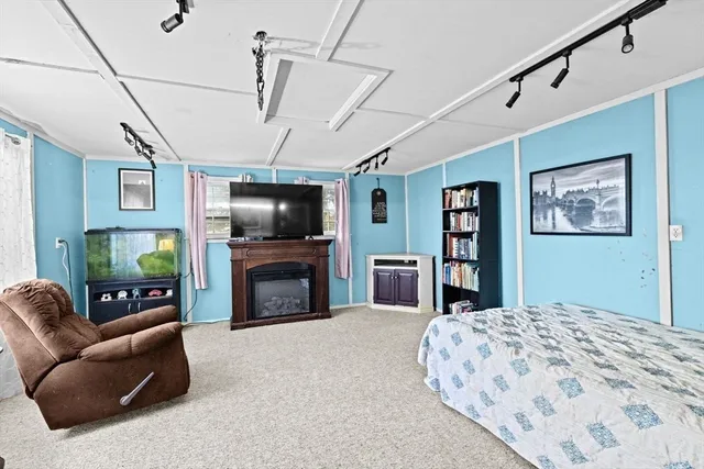 a bedroom with a large bed a book shelf and a book shelf