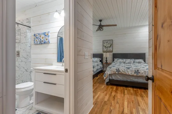 a bathroom with a sink a toilet and shower