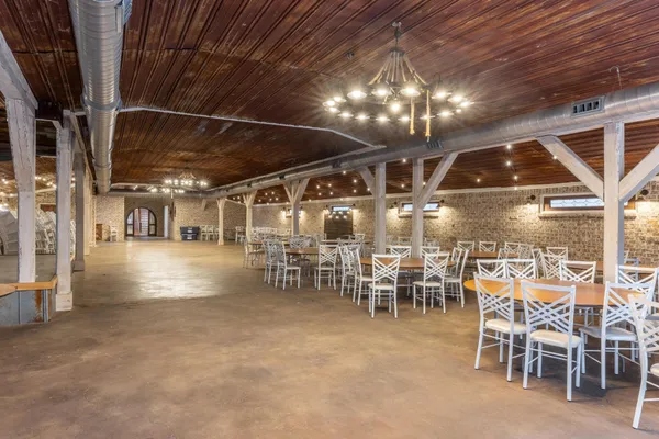 a bedroom with a bed and a window with chair