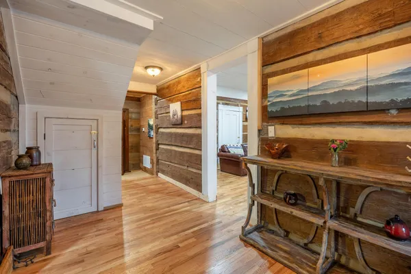 a view of a kitchen with wooden floor and a sink