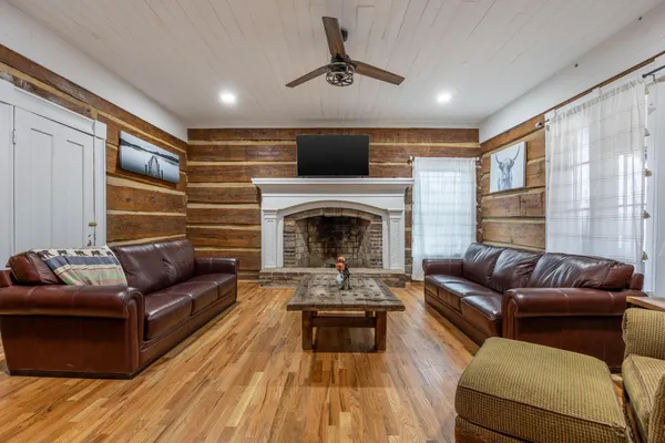 a living room with furniture and a fireplace