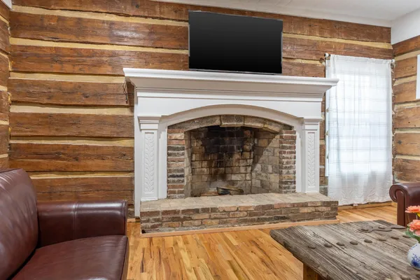 a view of fireplace and wooden floor