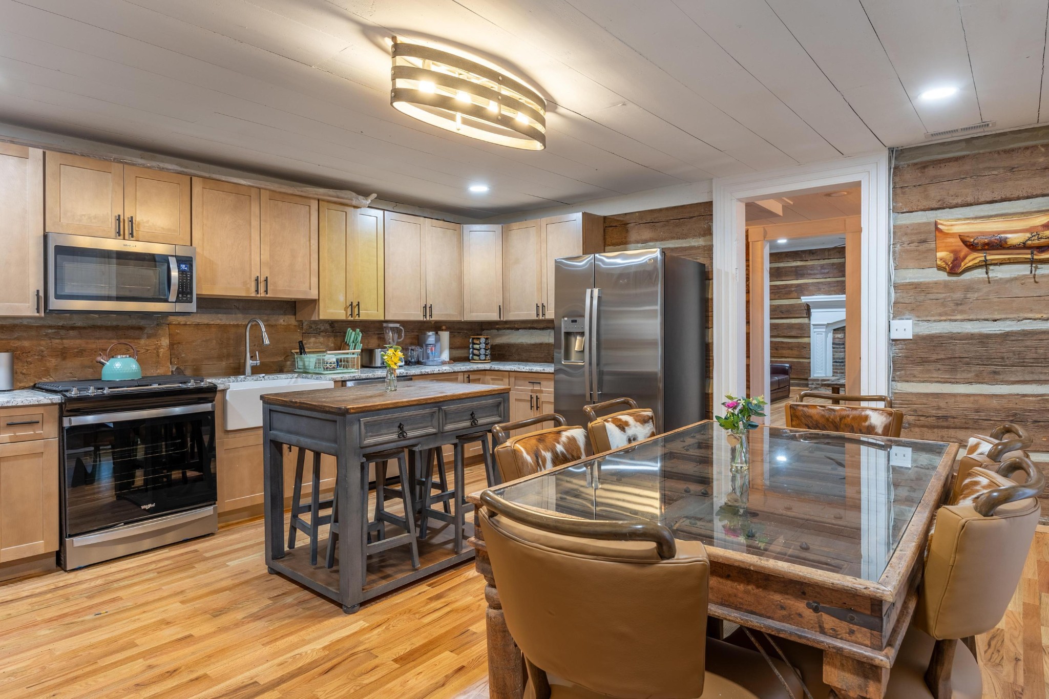 205 Us Highway Rising Fawn, GA 30738 - Photo 10 of 62 a kitchen with stainless steel appliances granite countertop a stove top oven a sink dishwasher a dining table and chairs with wooden floor