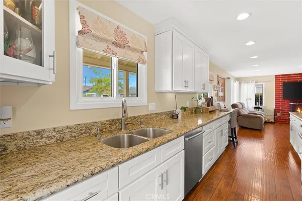 a kitchen with a sink stove and cabinets