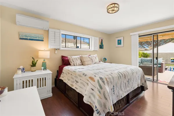 a bedroom with a bed a dresser and a window