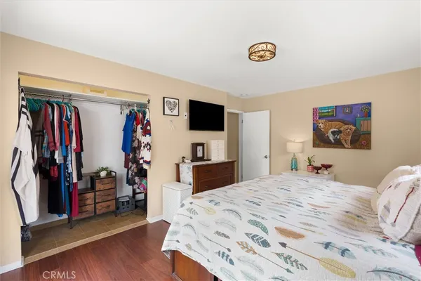 a bedroom with a bed and a television