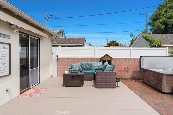 a couple of table and chairs in patio of house