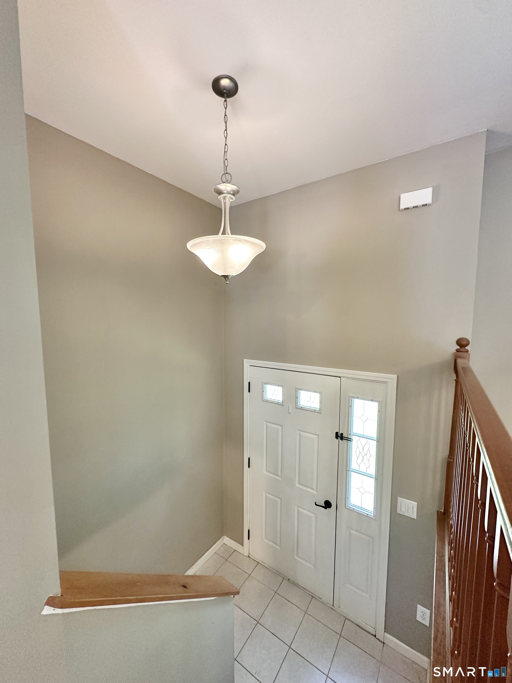116 Tatnic Hill Road Brooklyn, CT 06234 - Photo 11 of 27 a view of a hallway with a chandelier