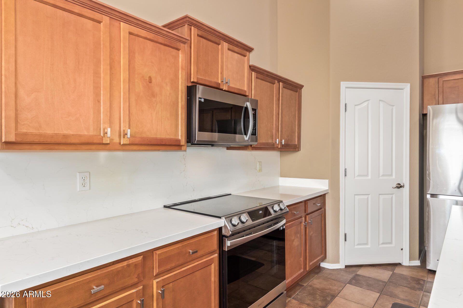 2115 West Branham Lane Phoenix, AZ 85041 - Photo 15 of 35 a kitchen with granite countertop a stove top oven microwave and cabinets