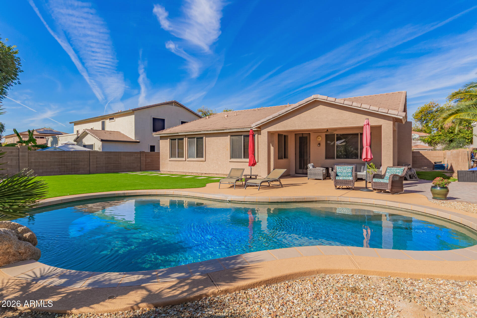 2115 West Branham Lane Phoenix, AZ 85041 - Photo 3 of 35 a view of a house with pool and chairs