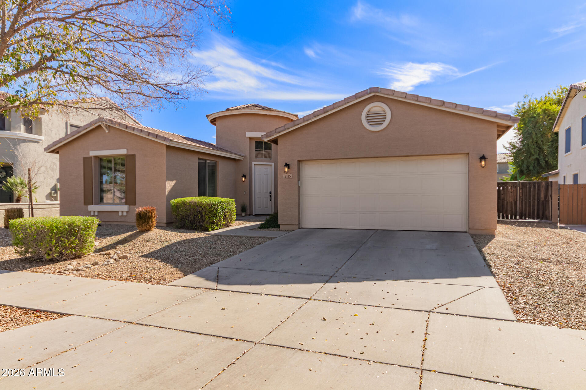 2115 West Branham Lane Phoenix, AZ 85041 - Photo 10 of 35 a front view of a house with a yard and garage