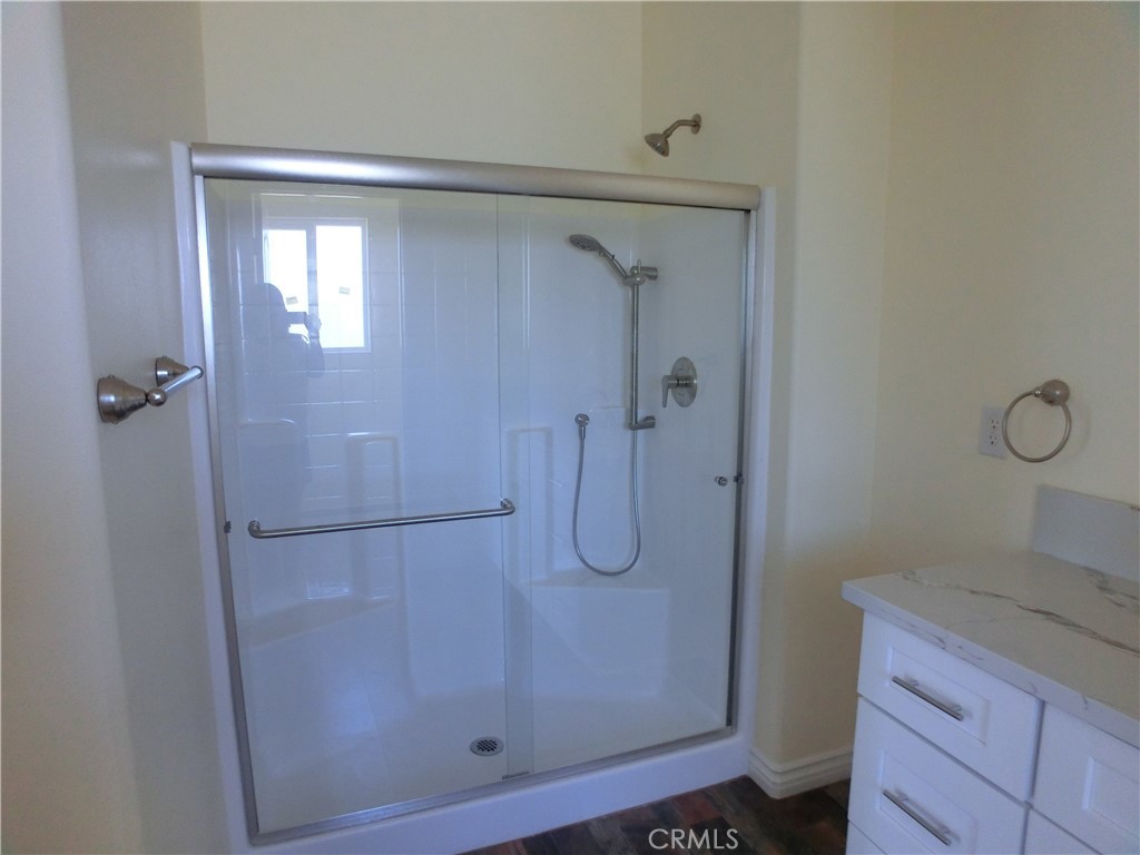 11462 Prado Road Pinon Hills, CA 92372 - Photo 15 of 18 a bathroom with a glass shower door