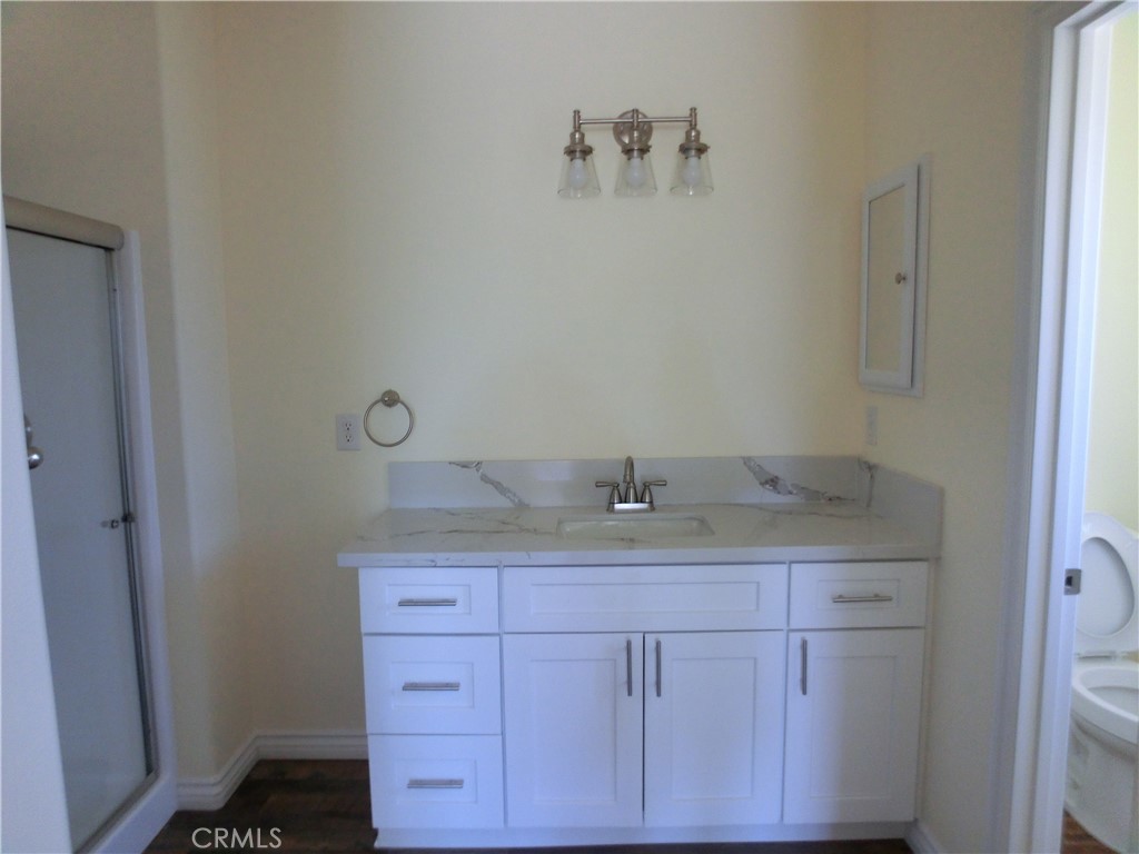 11462 Prado Road Pinon Hills, CA 92372 - Photo 16 of 18 a bathroom with a granite countertop sink and a mirror