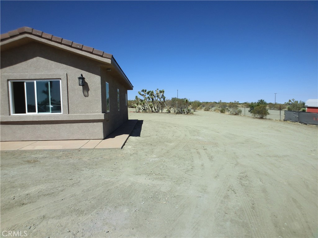 11462 Prado Road Pinon Hills, CA 92372 - Photo 5 of 18 a view of a house with a yard