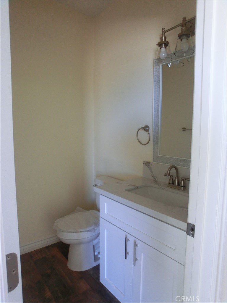 11462 Prado Road Pinon Hills, CA 92372 - Photo 10 of 18 a bathroom with a granite countertop toilet sink and mirror