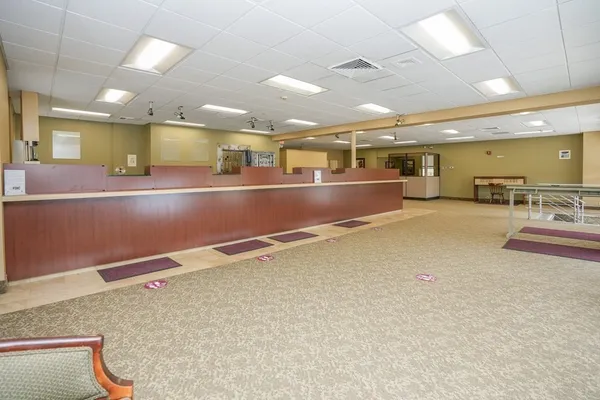 a room with lots of wooden furniture and a large window