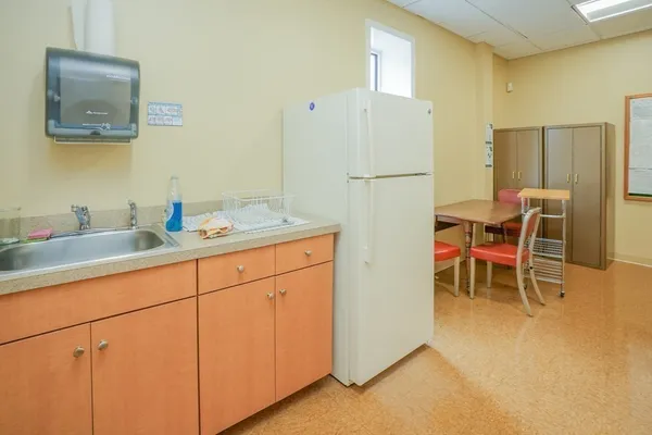 a view of a kitchen with a sink and large window