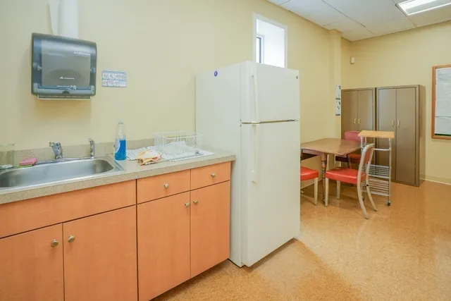 a view of a kitchen with a sink and large window